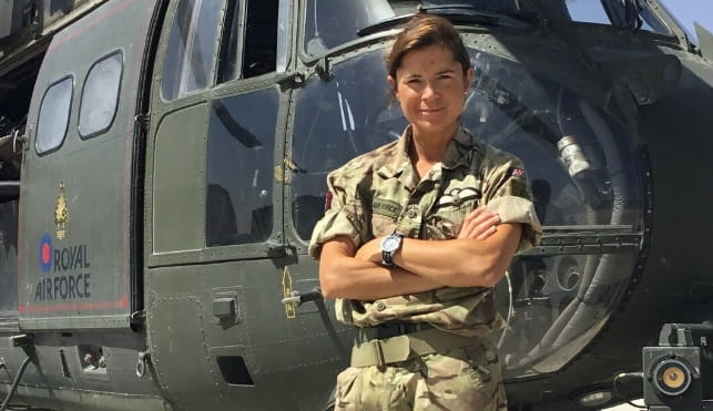 Sarah Furness standing in front of a helicopter